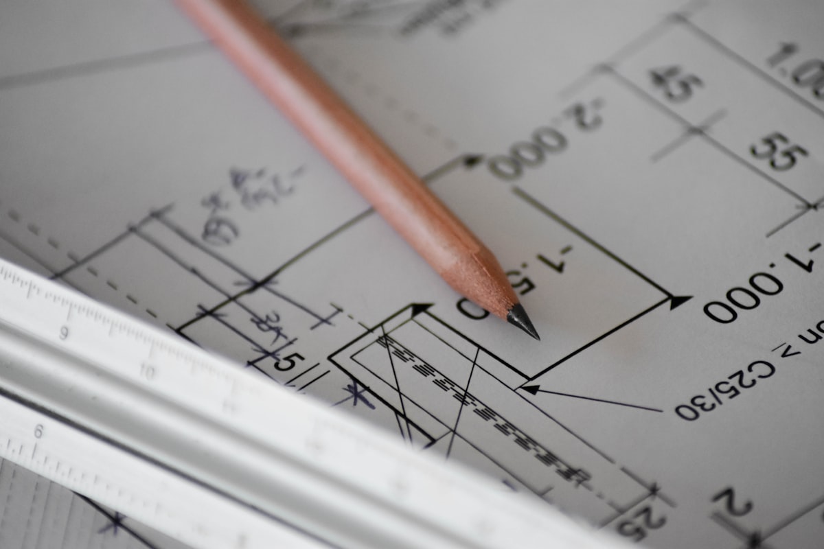 Architectural drawings and a pencil on a JANKO design table