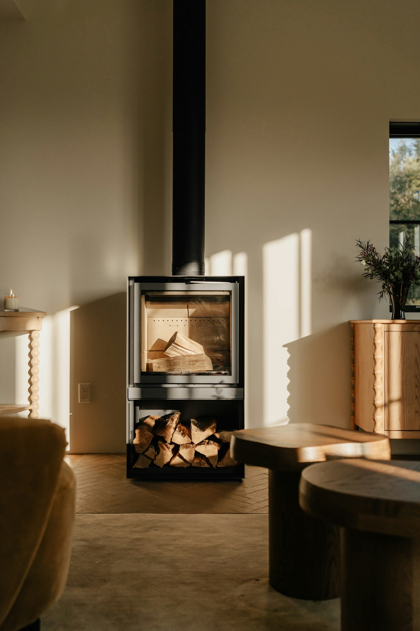 Whole-home renovation living space with a feature fireplace and warm natural light